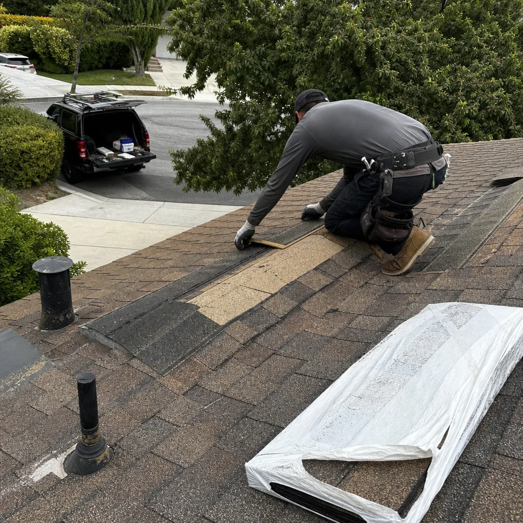 Professional roofer performing expert shingle repair on a residential home roof